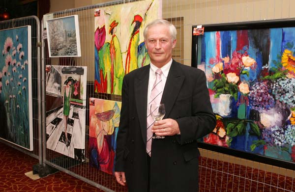 Arnold Wymen pictured with paintings by his wife Ans De Konig at the Castlebar Rotary Club Art sale (in conjunction with the Mayo Pink Ribbon Appeal) in Breaffy House Hotel, Castlebar. Photo:  Michael Donnelly