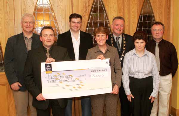 John OShaughnessy, chairman of the Mayo People in Need Committee, presents a cheque for 3,000 to Carmel Langan and Pauline Keane of Moy Chocolates, Ballina, at the distribution of 163,100 Euros collected in the "Telethon 2004 - People in Need" fundraising in the Welcome Inn Hotel Castlebar, included in photo are from left Joe Brett Western Care; James Kilbane; Pat Murray, President, Castlebar Chamber of Commerce and Michael Larkin. Photo Michael Donnelly