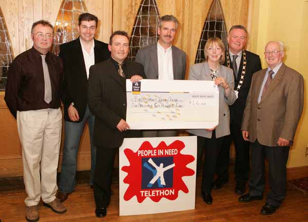 John OShaughnessy, chairman of the Mayo People in Need Committee, presents a cheque for 1,600 to Carmel Brady, Centre Manager Ballyhaunis Training Centre, at the distribution of 163,100 Euros collected in the "Telethon 2004 - People in Need" fundraising in the Welcome Inn Hotel Castlebar, included in photo from left: Michael Larkin, James Kilbane, James Rocke, Western Care; Pat Murray, President, Castlebar Chamber of Commerce and Tom Kenny. Photo Michael Donnelly