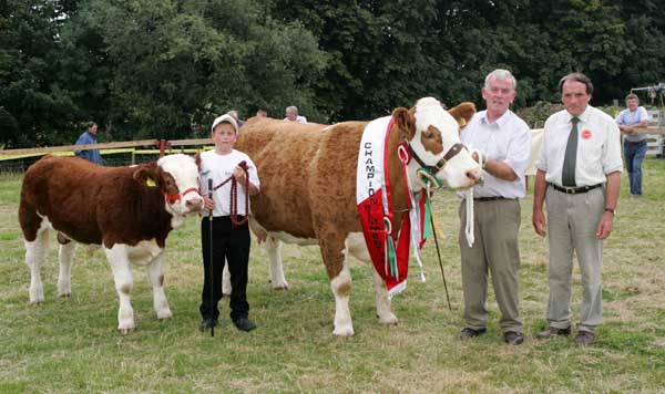 Darren McKeon Ballygawley Sligo  and Paddy Hennelly, Cregconnell Rosses Point Sligo with Seepa Shamus and Hillcrest Joan, Champion Simmental of Show at Ballinrobe Agricultural Show. Included in photo is Cattle Judge  Kenneth Stubbs Irvinestown Co Fermanagh.  Photo: Michael Donnelly.