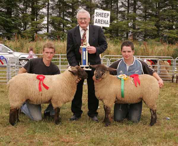 Joe Gilligan presents the Gilligan Trophy to Anthony Donnelly Ballyglass Scardane Claremorris  for Best Pair of Cross Bred  Ewe lambs, included in photo (on right) is Daniel Conway Ballyglass Scardane. Photo: Michael Donnelly.  