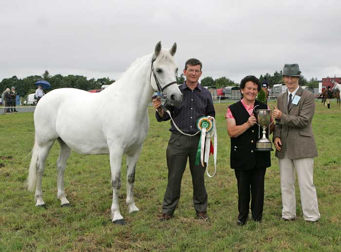 Breda Horan, Castlegar, Galway is presented with the cup for Champion Connemara by Sarah Jacob (judge), at the 88th Claremorris Agricultural Show, Roger Brady shows the champion Pony. Photo:  Michael Donnelly