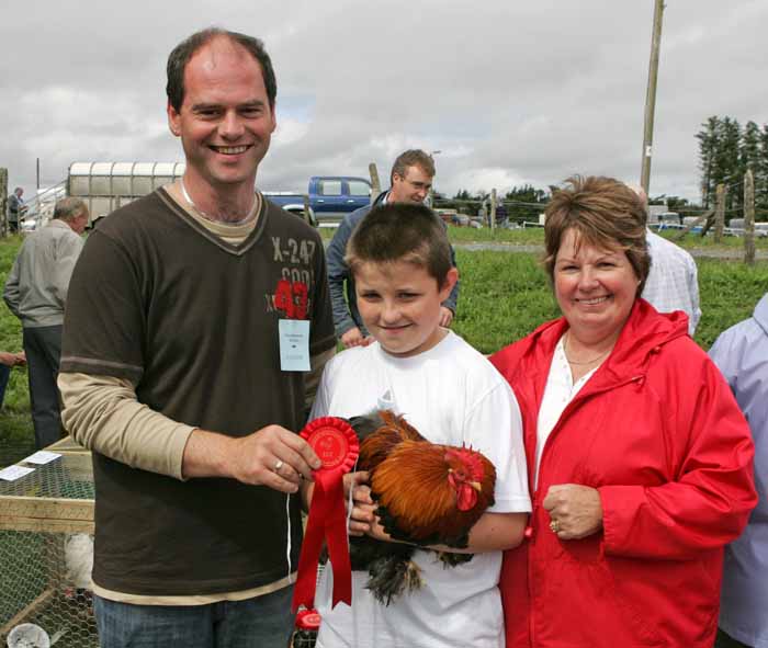 Daragh Sheridan, Tonacrick, Lahardane pictured with his prizewinning Partridge Pekin.  Included in photo are Ian Satchwell, Roscommon (judge), and Eileen Sheridan. Photo:  Michael 