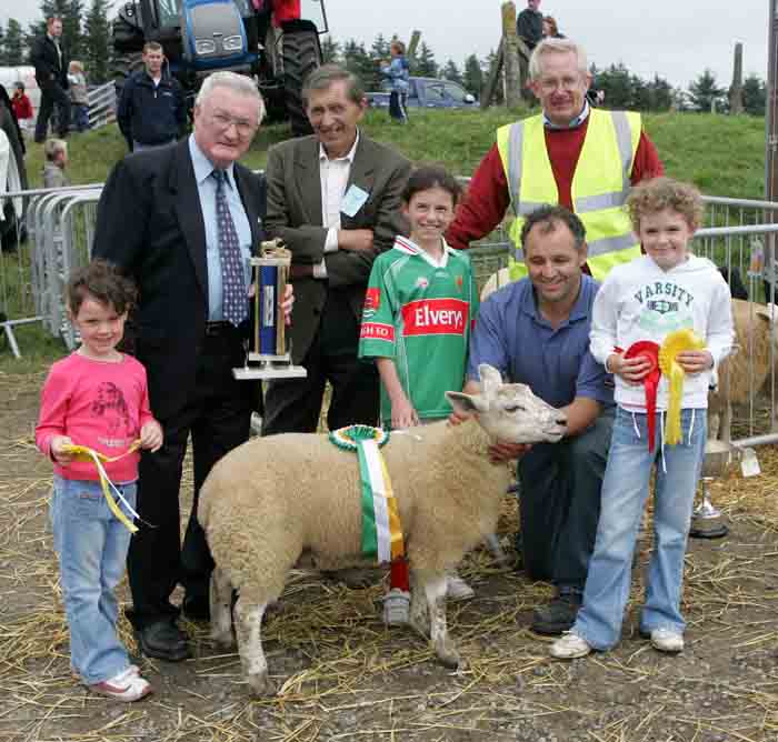 Joe Gilligan presents the Gilligan Trophy for Champion Crossbred Ewe lamb at the 88th Claremorris Agricultural Show, to Walter Brennan. Included in photo from left; Aoife Brennan, Brenda Finlay,  Walter Brennan and Laura Brennan. At back: Joe Gilligan, Patsy Reilly (judge) and John Walter, show steward. Photo:  Michael Donnelly