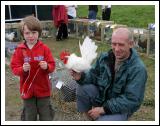 John Kenneth Dowling, Crossmolina holding his red rosette for his Bantan Cock, at the 88th Claremorris Agricultural Show, pictured with his dad John Dowling. Photo:  Michael Donnelly