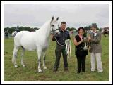 Breda Horan, Castlegar, Galway is presented with the cup for Champion Connemara by Sarah Jacob (judge), at the 88th Claremorris Agricultural Show, Roger Brady shows the champion Pony. Photo:  Michael Donnelly