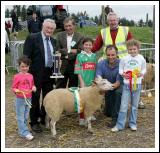 Joe Gilligan presents the Gilligan Trophy for Champion Crossbred Ewe lamb at the 88th Claremorris Agricultural Show, to Walter Brennan. Included in photo from left; Aoife Brennan, Brenda Finlay,  Walter Brennan and Laura Brennan. At back: Joe Gilligan, Patsy Reilly (judge) and John Walter, show steward. Photo:  Michael Donnelly