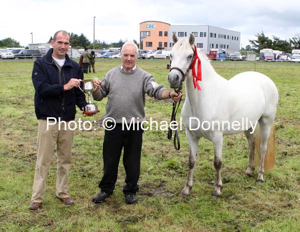 Tom Butler presents the Eddie Butler Memorial Cup to Jarlath Grogan, Bekan Claremorris and Mountain Heather for Junior Champion Pony at Claremorris Agricultural Show. Photo:  Michael Donnelly.  