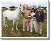 Gerry McCormack Kinvarra (showing on behalf of Breda Horan, Castlegar, Galway) is presented with the Irish Plastics Development Trophy for best Registered Connemara Mare 8 years or over  by Sarah and Kevin Jacobs (Judges). Photo:  Michael Donnelly
