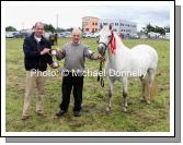 Tom Butler presents the Eddie Butler Memorial Cup to Jarlath Grogan, Bekan Claremorris and Mountain Heather for Junior Champion Pony at Claremorris Agricultural Show. Photo:  Michael Donnelly.  