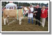 Garrett Behan, Ballyfin, Portlaoise is presented with the Joseph Dowd Memorial Cup by Luke Gibbons Claremorris (sponsor) at Claremorris Agricultural Show after winning the All Ireland Pedigree Suckler Type Heifer Championship, also in photo is Dorothea Lazenby, National Chairman Irish Shows Association. Photo:  Michael Donnelly