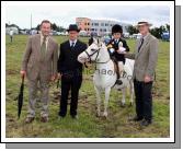 Three Generations of Foys, from Westport, from left: Paddy Joe, Padraic and Molly Foy with the winner of the U-10 lead rein at Claremorris Agricultural Show and judge Pascal Crawfords. Photo:  Michael Donnelly