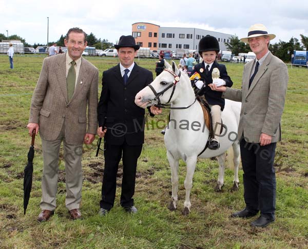 Three Generations of Foys, from Westport, from left: Paddy Joe, Padraic and Molly Foy with the winner of the U-10 lead rein at Claremorris Agricultural Show and judge Pascal Crawfords. Photo:  Michael Donnelly