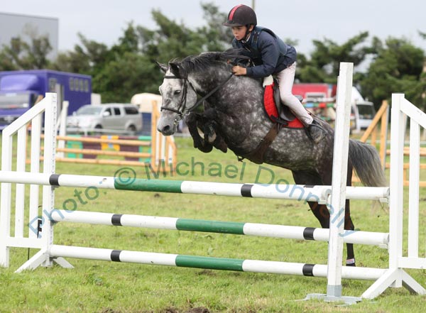 Cormac Hanley Jnr, Claremorris, on Emerald Pride clears the final jump to win the 138 ABC  Claremorris Show Jumping section at Claremorris Agricultural Show. Photo:  Michael Donnelly