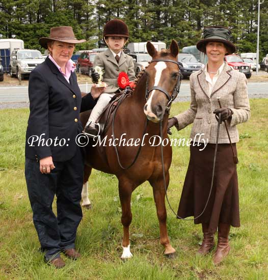 Patricia Hoey, (Judge)   presents 1st prize to Ben Crawford Corofin  on Tabita Pollyanna winner of Lead Rein at Claremorris Agricultural Show led by Claire Crawford, Corrofin, Co. Galway. Photo:  Michael Donnelly
