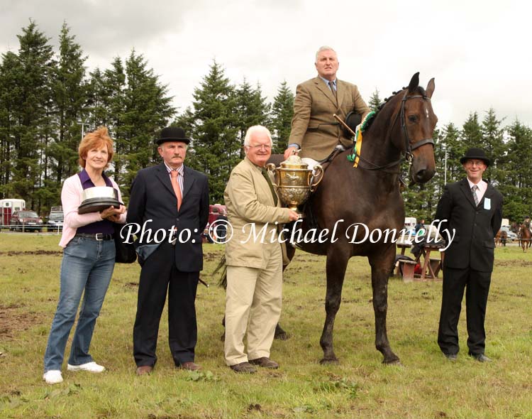Cormac Hanley (sponsor) presents the Oliver Dixon Gold Cup to David McCormack, Mullingar, for Champion Hunter under Saddle at Claremorris Agricultural Show, included in photo are Claire Byrne (Show committee) and judges James McWeeney, Leitrim and  James Murphy, Swinford. Photo: Michael Donnelly.