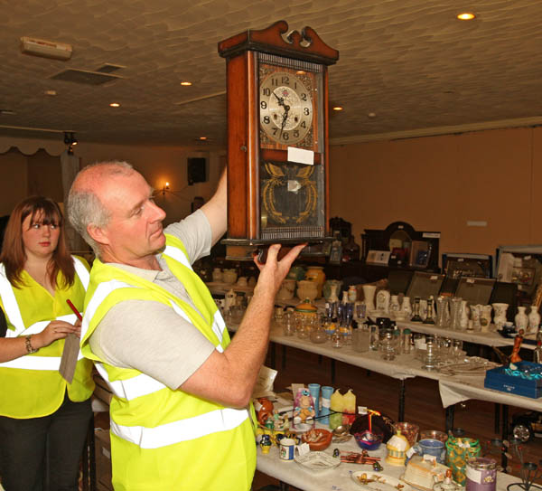 TJ Kelly  of Midfield Development Association displays a Clock (one of the many items) at the 24 Hour Auction in Julians of Midfield Swinford in an attempt to break a record in the Guinness book of Records. 