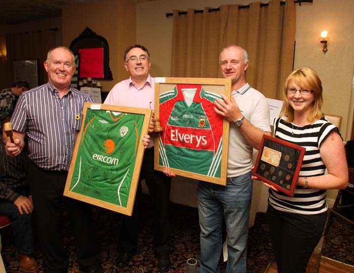Auctioneers Joe Mellett and Matt Duggan Swinford  pictured with TJ Kelly and Kathleen Brennan of Midfield Development Association displaying Framed Jerseys, some of the many items at the 24 Hour Auction in Julians of Midfield Swinford in an attempt to break a record in the Guinness book of Records.Photo:  Michael Donnelly