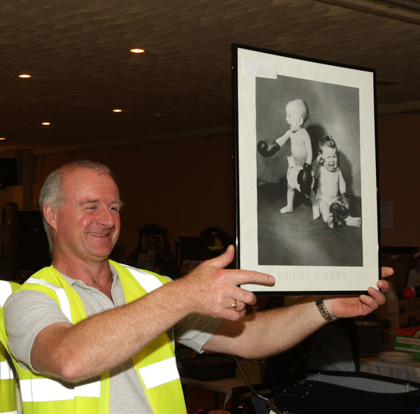 TJ Kelly of Midfield Development Association displays a Framed photo (one of the many items) at the 24 Hour Auction in Julians of Midfield Swinford in an attempt to break a record in the Guinness book of Records.Photo:  Michael Donnelly
