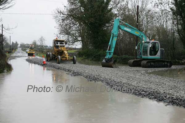 Mayo Co Co workmen raise the road level at Ballytrasna just outside Ballinrobe on the Kilmaine Road. Photo:  Michael Donnelly