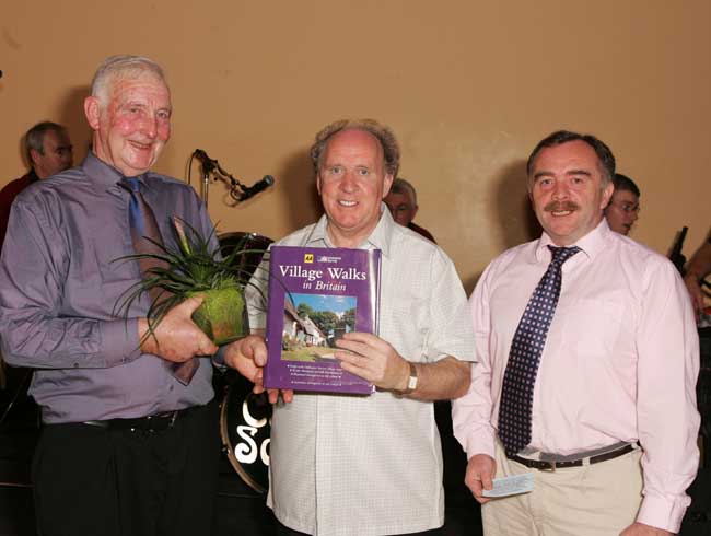 Paddy Walsh, Kilmaine makes a presentation to Kevin Prendergast (Guest) at the Threshing Social in the Dalton Inn Hotel Claremorris. Included on right is Gerard Delaney MC for the night.  Photo: Michael Donnelly.