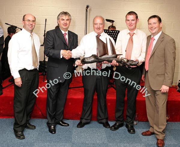 Pat Daly, Building Contractor makes a presentation of a  specially commissioned "Galway Hooker in Bog Oak to the Directors of CBE at the official opening of CBE's new Head Office and Research and Development Centre in Claremorris,  from left: Sean Kenna, Gerry Concannon, CEO and Chairman of CBE; Pat Daly, who built the new premises; Sean Kenny, Project manager Pat Daly Construction and Seamus Murray, Financial Controller CBE. Photo:  Michael Donnelly