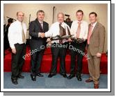 Pat Daly, Building Contractor makes a presentation of a  specially commissioned "Galway Hooker in Bog Oak to the Directors of CBE at the official opening of CBE's new Head Office and Research and Development Centre in Claremorris,  from left: Sean Kenna, Gerry Concannon, CEO and Chairman of CBE; Pat Daly, who built the new premises; Sean Kenny, Project manager Pat Daly Construction and Seamus Murray, Financial Controller CBE. Photo:  Michael Donnelly