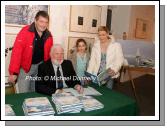Northabout skipper Jarlath Cunnane pictured as he signs his book Northabout (sailing the North East and North West Passages) in the Linenhall Arts Centre Castlebar, included in photo are Rory Casey who also sailed on Northabout and Kate and Eavan Mongey Castlebar. In background is a photo from the the expedition. Photo:  Michael Donnelly
