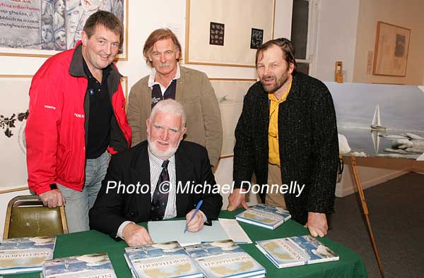 Northabout skipper Jarlath Cunnane pictured as he signs his book Northabout (sailing the North East and North West Passages) in the Linenhall Arts Centre Castlebar, included in photo are Rory Casey, Castlebar, Michael Brogan, Ballyhaunis and Jamie Young, The Killary, Co Galway who all sailed on Northabout  In background is a photo from the the expedition. Photo:  Michael Donnelly