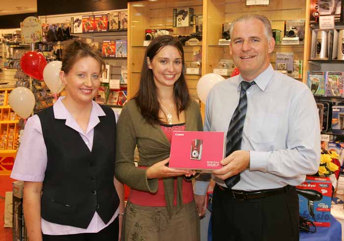 Pat Staunton presents a Canon IXUS i5 digital camera to Mayo Rose of Tralee Aoibhinn N Shilleabhin, a former member of staff of Stauntons Photo Shop. Included in photo is Mary Moran manageress  Stauntons Digital One Hour Photo. Photo: Michael Donnelly.