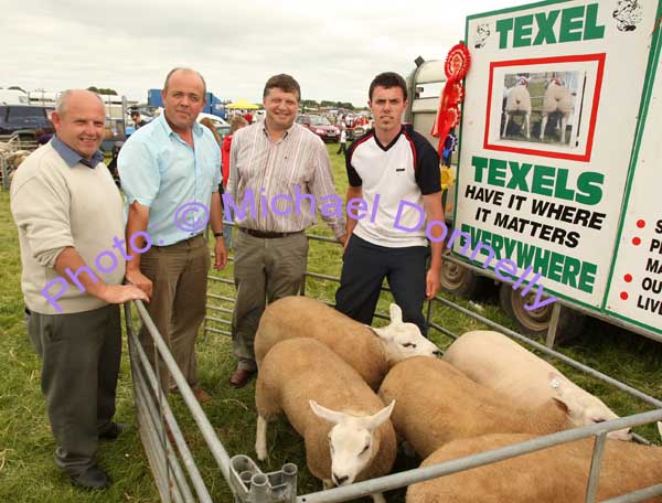 David Coen, Lehinch, Hollymount, (on right), who won the Champion Pedigree Sheep title at Roundfort Agricultural Show, shows his prizewinning pen to from left: Cllr Patsy O'Brien, Liam Coen, and Deputy John O'Mahony. Photo Michael Donnelly