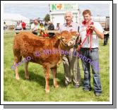 Ciaran Golden Carrowholly Westport won 1st and 2nd prize in Young Heifer Calf (Limousin) at Roundfort Agricultural Show shown by Shane McGreal Ballinrobe, included in photo is Owen O'Neill (Judge) Limerick. Photo Michael Donnelly