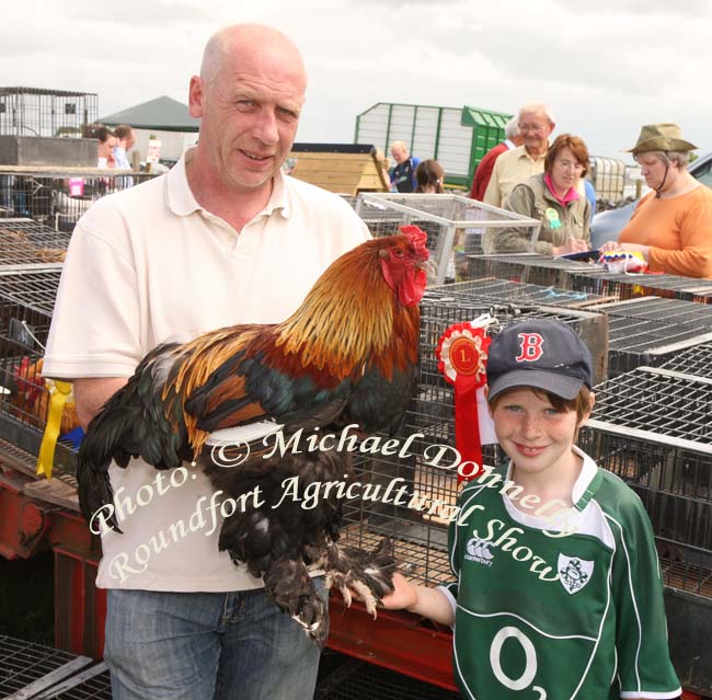 John and John Kenneth Dowling, Crossmolina with their champion Heavy Cock, Soft Feather at Roundfort Agricultural Show, Co Mayo. Photo:  Michael Donnelly