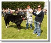 Ciaran Golden, Westport, (showing a Limousin/Belgian Blue cross heifer calf, ) (out of "Rocky" Limousin) winner of the Roundfort Young Stockperson Championship at Roundfort Agricultural Show is presented with the Kathleen Nally Memorial Perpetual Cup by Claire Nally. Photo:  Michael Donnelly