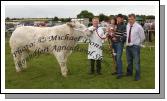 Robert Burns, Easkey Co. Sligo is presented with the Martin Joe Shaughnessy Memorial Cup by Michaela Murphy and Martin Shaughnessy (son)  at Roundfort Agricultural Show, included in photo is Gordon Cutler (Judge) Enniskillen. Robert also won the Laragan Lime, All Ireland Beef Bullock Qualifier (sponsored by Hanley Bros, Laragan, Strokestown and  the Champion of Show. Photo:  Michael Donnelly 