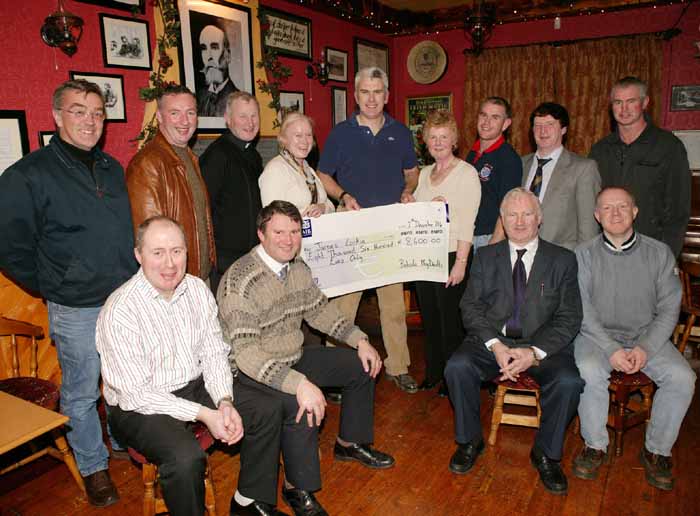 James Larkin wins the Moy Davitts Lotto of 8,600  pictured under the portrait of Michael Davitt, original patron of the GAA  in the Copper Beech Straide. Why the group should be all smiles is somewhat strange, because they have just handed out 8600!  Nonetheless congratulations to James, a former player for the club and we hope he enjoys every cent of it.  The Lotto was last won in May 2003. Its only 2 for a ticket. You could be the person with the smile on your face. But if you're not in, the chances of winning are considerably reduced!  
Included in photo Front from left: Tony Byrne, Michael McDonagh, John McNicholas (Chairman), Paul Sherry.
Back Row Left to right: Kevin Hennigan, Gerry Quinn, Fr Padraig Costello, Angela Ruane (Secretary), James Larkin, (Lotto winner) Bernadine Malee, Club treasurer, Gary Ruane, Joe McEveigh, and Michael Ruane. Photo Michael Donnelly 
