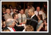 Guest of Honour Paul McGrath signs an autograph for Bernie Burke at the Western People Mayo Sports Awards 2006 presentation in the TF Royal Theatre Castlebar. Photo:  Michael Donnelly