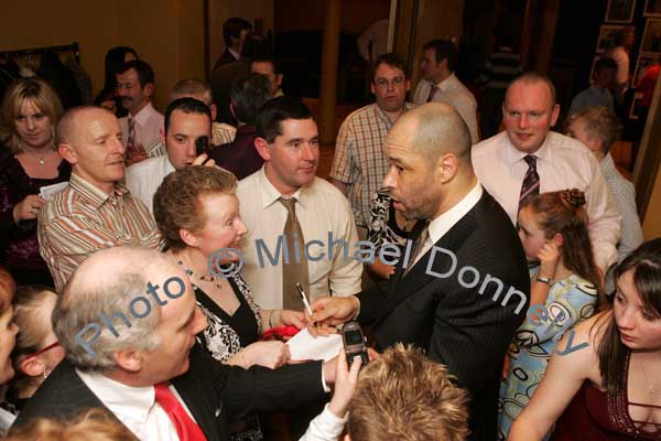 Guest of Honour Paul McGrath signs an autograph for Bernie Burke at the Western People Mayo Sports Awards 2006 presentation in the TF Royal Theatre Castlebar. Photo:  Michael Donnelly