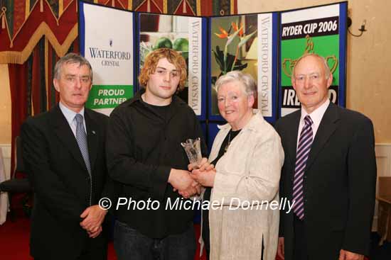Justin Collins of Mullingar Harriers is presented with his award at the Waterford Crystal A.A.I,  Juvenile Star Awards in the Belmont Hotel, Knock by  Breda Synott chairperson National Juvenile Committee AAI, included in photo are Patsy McGonagle Vice-president AAI and Michael Gaffney, Waterford Crystal (sponsor). Photo Michael Donnelly

