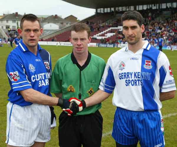 Captains shake hands, from left Odhran O'Dwyer, Kilmurry Ibrickane; Joe McQuillan (Cavan) referee; and Brian Ruane Ballina Stephenites. Photo Michael Donnelly