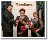 Edwin McGreal of the Mayo News presents the Hall of Fame award to Sheila Mangan Belmullet at the Mayo News Mayo Athletic Awards, in Hotel Westport while Marian Mattimoe, PRO Mayo Athletic Board presents her with a Bouquet of flowers. Photo:  Michael Donnelly