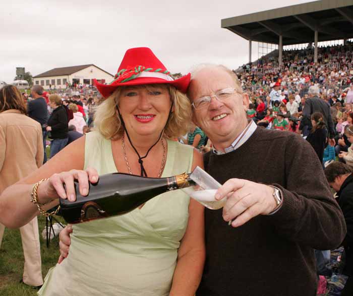 Mary Maguire Claremorris pours a glass of Champagne for Paul Claffey after Mayo defeated Laois which was shown on the Big Screen at the  "Craic on the Track" at Ballinrobe Racecourse.  Photo: Michael Donnelly.