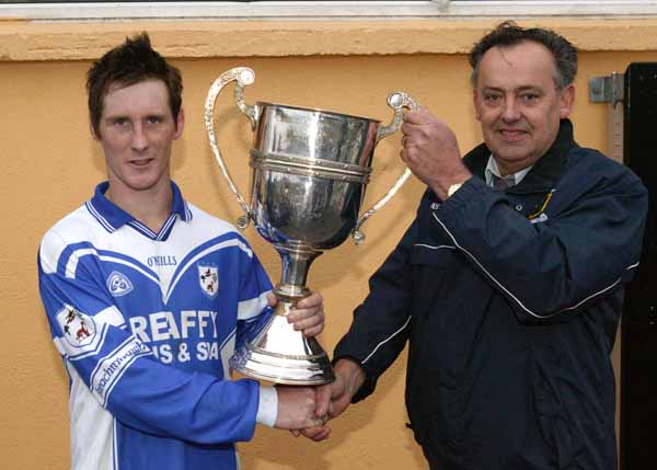 Paddy Naughton chairman Mayo GAA County Board presents the James Sweeney Memorial Cup to Gerry Jennings captain of Breaffy after they defeated Ballaghaderreen l  in the Breaffy House and Spa  County Intermediate  Football Championship Final in McHale Park Castlebar. Photo: Michael Donnelly
