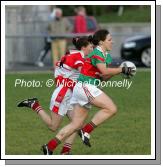 Carnacon captain Martha Carter is pursued by Sharon Courtney  Donaghmoyne (Monaghan) in the VHI Healthcare All Ireland Ladies Club Championship Senior Final 2006 at Dromard Co Longford. Photo:  Michael Donnelly