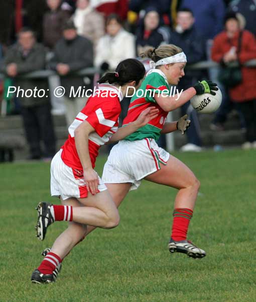 Fiona McHale Carnacon is pursued by Fiona Courtney (capt.) Donaghmoyne (Monaghan) in the VHI Healthcare All Ireland Ladies Club Championship Senior Final 2006 at Dromard Co Longford. Photo:  Michael Donnelly