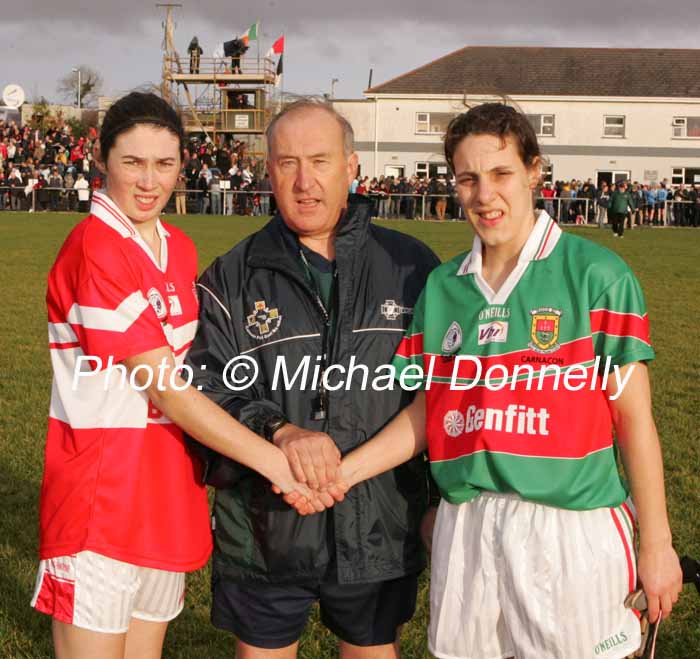 Captains exchange greetings prior to the VHI Healthcare All Ireland Ladies Club Championship Senior Final 2006 at Dromard Co Longford, from left Fiona Courtney, Donaghmoyne (Monaghan); referee Tony Clarke Dublin and Martha Carter Carnacon. Photo:  Michael Donnelly