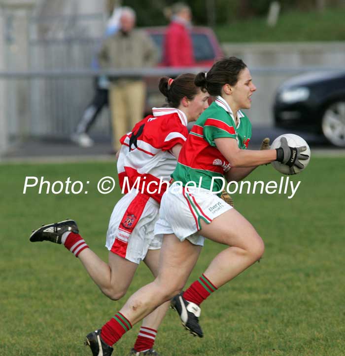 Carnacon captain Martha Carter is pursued by Sharon Courtney  Donaghmoyne (Monaghan) in the VHI Healthcare All Ireland Ladies Club Championship Senior Final 2006 at Dromard Co Longford. Photo:  Michael Donnelly