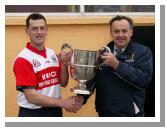 Paddy Naughton, Chairman Mayo GAA County Bard presents the Pete McDonnell Memorial Cup to Aughamore  captain Liam Walsh after they defeated Ballina Stephenites B in the Breaffy House and Spa  County Junior  Football Final in McHale Park Castlebar. Photo: Michael Donnelly