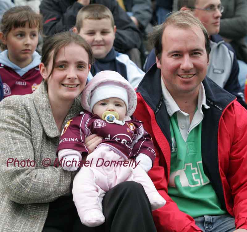 5 month old Michaela Mullaney Crossmolina pictured with her parents Aisling and Keith, was probably the youngest supporter in McHale Park Castlebar at the Lynch Breaffy House Hotel and Spa County Senior Football Final Replay between Crossmolina and Ballagaderreen. Photo:  Michael Donnelly