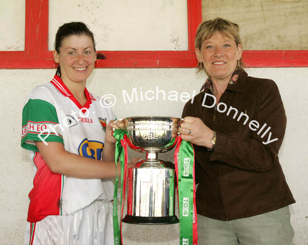 Christina  Heffernan is presented with the CBE Cup by Mary Quinn, President Ladies GAA Connacht Council after Mayo defeated Galway in the Connacht Ladies Football TG4 Senior Championship final in Tuam. Photo:  Michael Donnelly